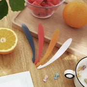 Set of four colorful silicone fruit spoons in blue red orange and white ideal for decorbites citrus zester peeler use