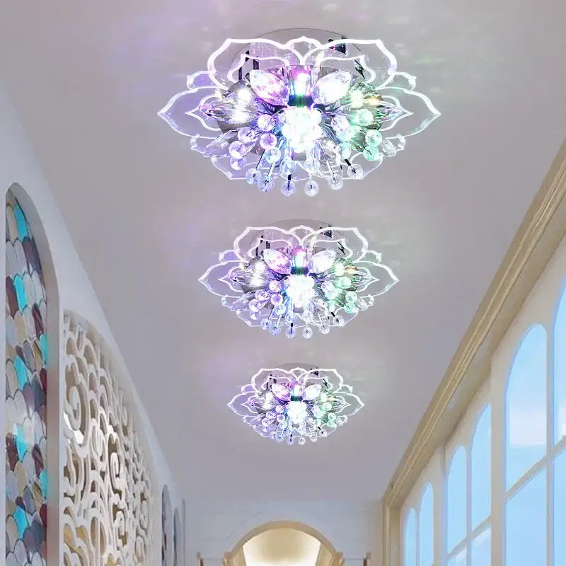 Three elegant colorful crystal flower ceiling light fixtures with multicolored lights and clear glass elements for living room