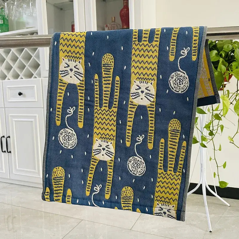 Blue towel with yellow and white cartoon cats hanging on a metal rack from colorful dinosaur cat gauze hand towels set decorbites cat gauze hand