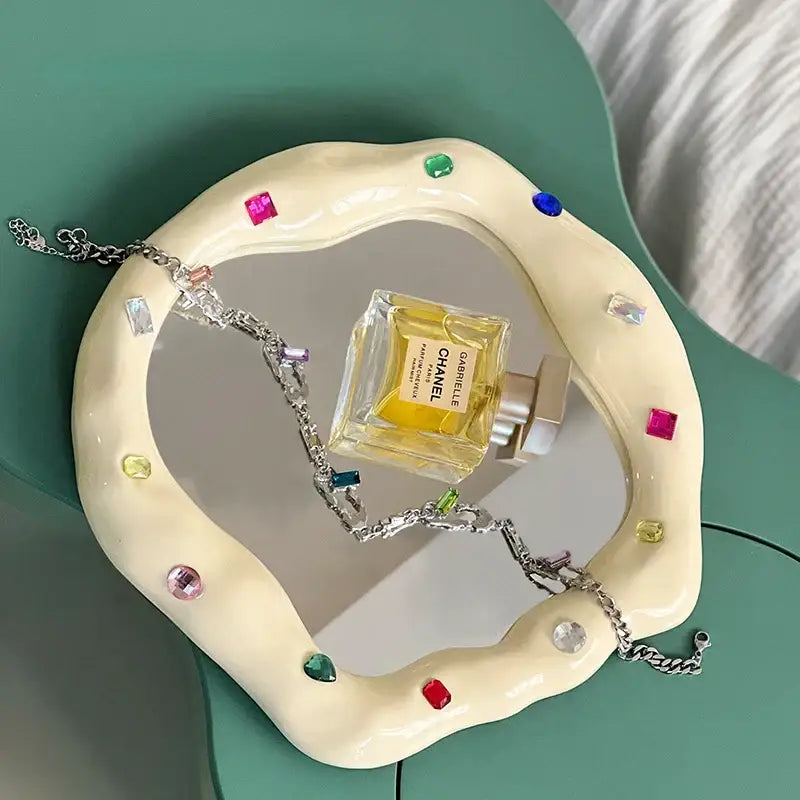 Cream-colored ceramic makeup mirror with irregular edge and colorful gemstones for bedroom use