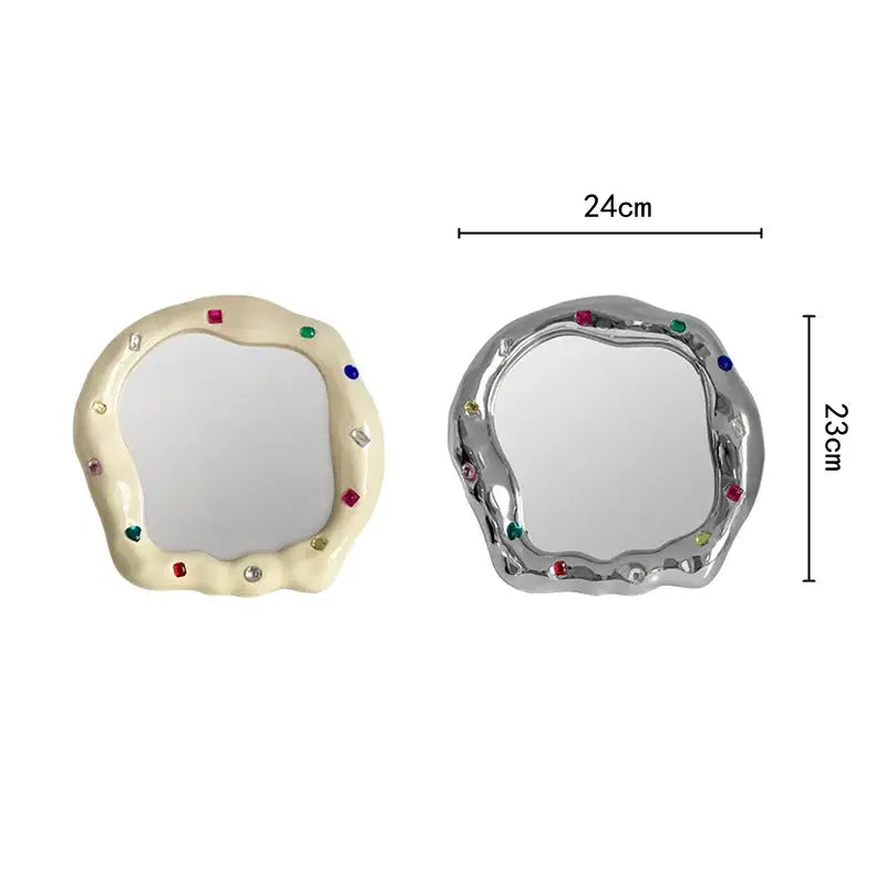 Cream and silver ceramic makeup mirror with irregular edge adorned with colorful gemstones for bedroom use