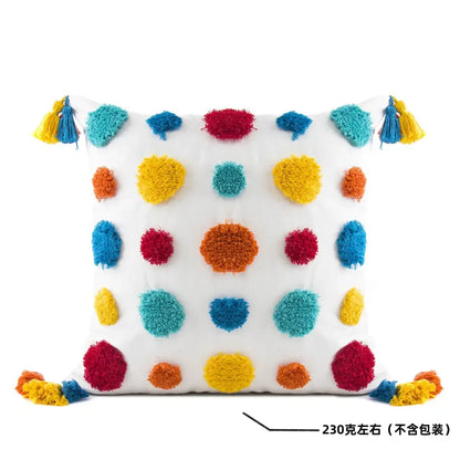 White cushion with colorful fluffy pom-poms and tassels in red yellow blue and orange decorbites geometric tassel pillowcase