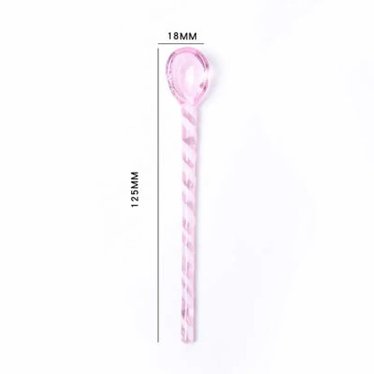 A translucent pink colorful glass stirring spoon with a twisted handle and oval bowl for kitchen use by decorbites colorful glass