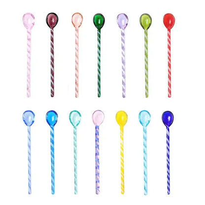 A set of colorful glass stirring spoons with translucent spiral patterns and rounded heads for kitchen and dining use