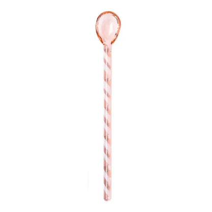 A translucent rose gold stirring spoon with twisted stripes and smooth handle from decorbites colorful glass set
