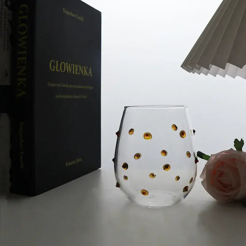 Clear glass stemless wine glass with golden circular embellishments from colorful glass wave dots mug set