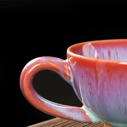 A colorful glazed porcelain tea cup and saucer set with a glossy gradient from orange to purple and teal accents