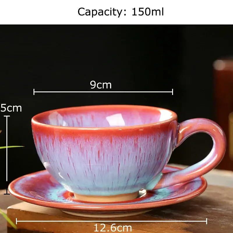 A colorful glazed porcelain tea cup and saucer set with a gradient from vibrant red to soft blue for dining decor