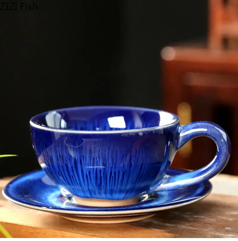 Vibrant cobalt blue colorful glazed porcelain tea cup with radial brushstroke texture on matching saucer set