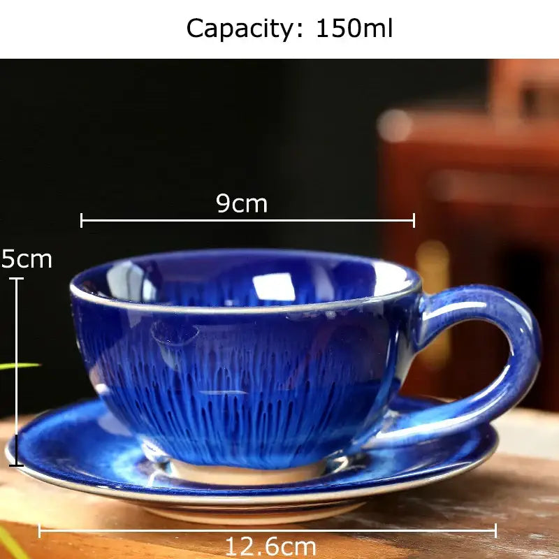 A deep blue colorful glazed porcelain tea cup with radial textured pattern and matching saucer set for dining room decor