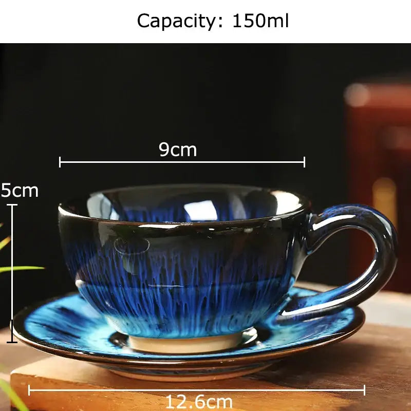 A colorful glazed porcelain tea cup and saucer set with a glossy deep blue to black gradient for dining room decor