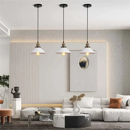 Three white pendant lights with black cords and brass accents in colorful industrial loft pendant light decorbites style
