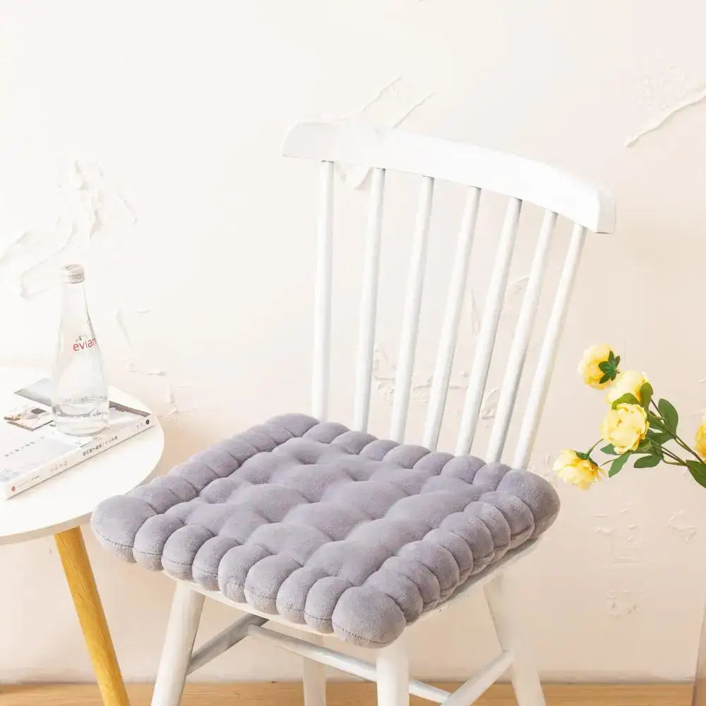 Gray quilted cookie biscuit cushion with soft plush texture and rounded tufting for living room decoration