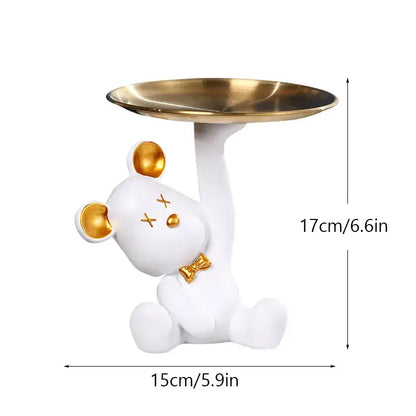 White resin bear house entry tray keys receiver with gold accents holding brass tray for living room use