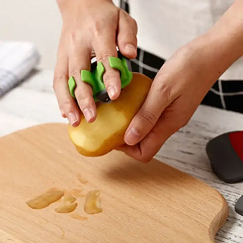 Green silicone potato peeler with ergonomic finger grips for easy peeling by decorbites fruit peeler slicer