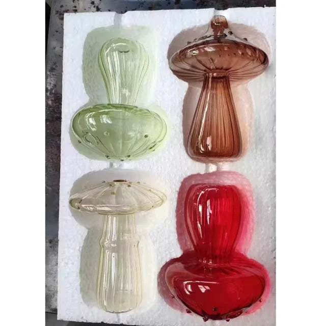 Four translucent glass mushroom-shaped vases in green amber clear and red for desktop hydroponic decoration