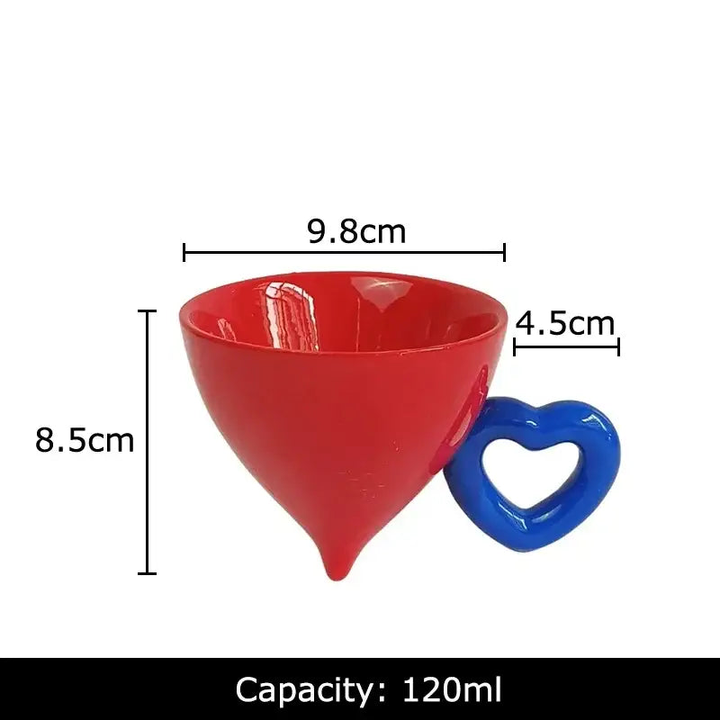 A vibrant red glossy ceramic coffee mug with a heart ceramic blue handle and tapered conical shape from decorbites heart ceramic