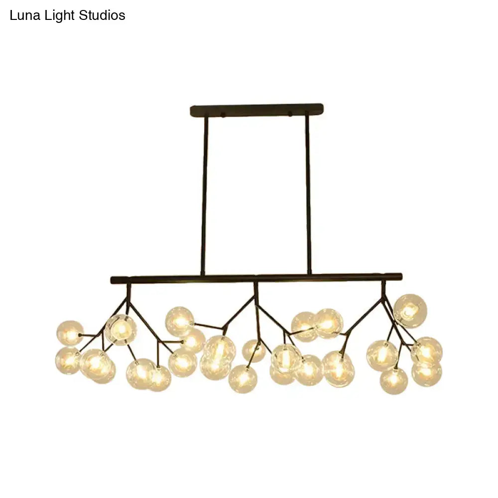 Modern black metal chandelier with frosted glass globe bulbs in a branching design for bubbles island lighting