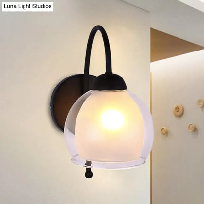 Contemporary black metal wall sconce with a frosted glass globe shade ideal for bedroom lighting