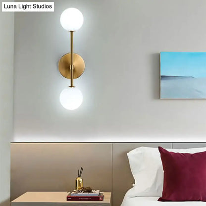 Contemporary black and gold wall lamp inch fixture with dual frosted glass globes for bedroom lighting