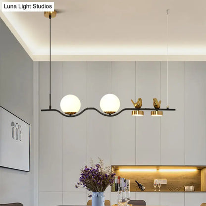 Modern black metal pendant light with cream glass balls and gold bird decor for branch dining room island lighting