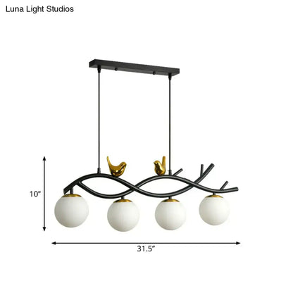Decorbites™ black metal linear branch dining chandelier with gold bird accents and four cream glass ball shades