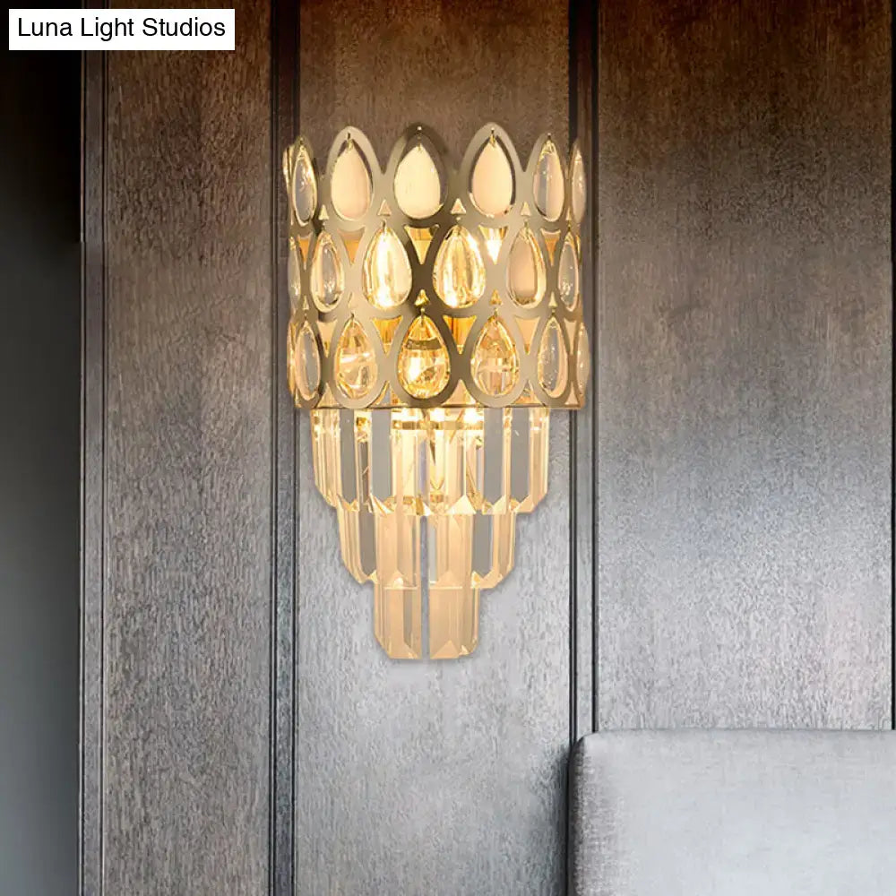 Contemporary black gold sconce featuring a grid wall mount with tiered geometric frame and cascading teardrop crystals