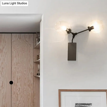 Contemporary black metal wall sconce with two frosted glass globe shades and clear glass shade for wall light