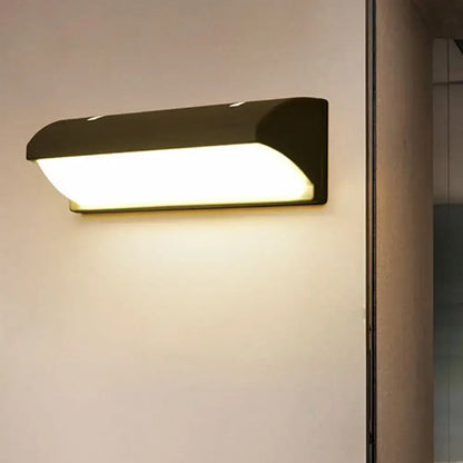 Contemporary black led wall lamp with sleek rectangular design and warm white illumination for courtyard or indoor use