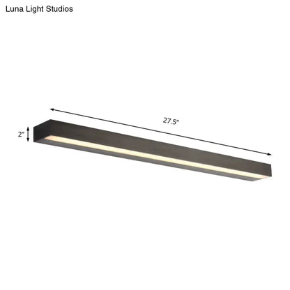 Contemporary black and silver linear vanity sconce with matte black rectangular led fixture and warm white illumination