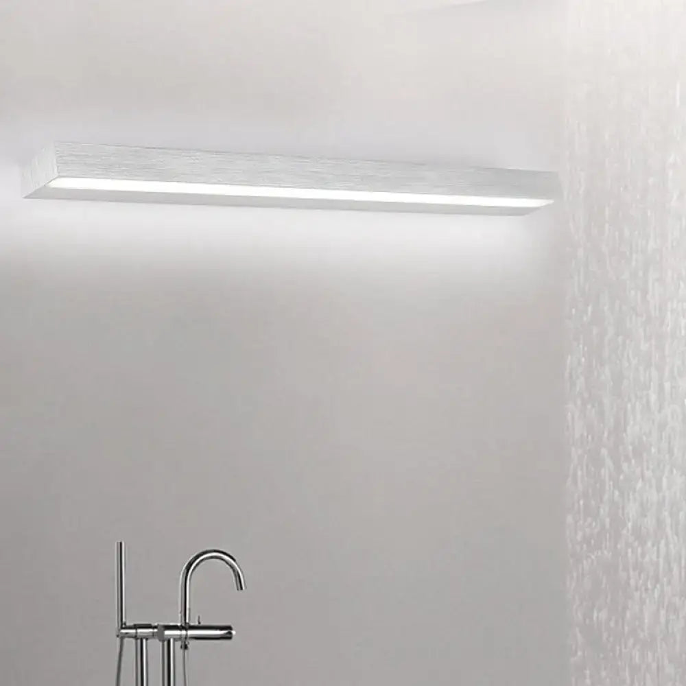 Contemporary black and silver linear vanity sconce with brushed metallic finish and integrated diffuser for white warm light