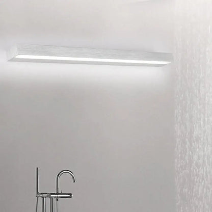 Contemporary black and silver linear vanity sconce with brushed metallic finish and integrated diffuser for white warm light