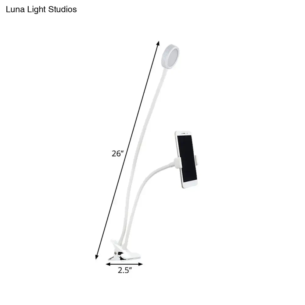Contemporary black and white flexible led desk lamp with white gooseneck, circular led light head, and phone clamp for bedroom use
