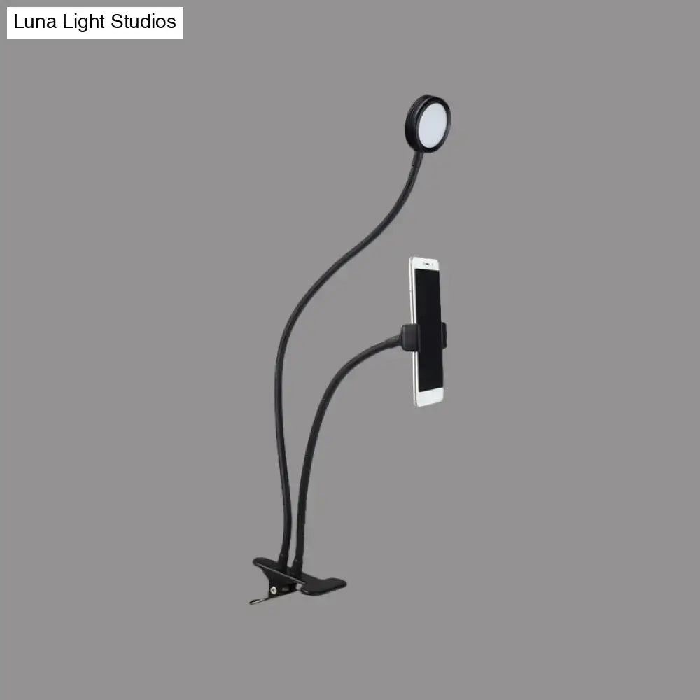 Contemporary black flexible led desk lamp with gooseneck phone clip and circular light head for bedroom use