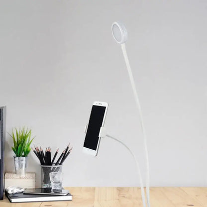 Contemporary white flexible led desk lamp with circular light head and phone holder for bedroom use