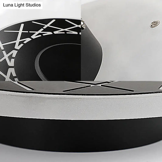 Contemporary black and white geometric wall lamp with circular x-pattern design for living room decor