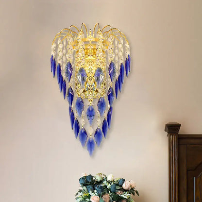 Contemporary brass wall lamp with gold-toned frame and cascading blue and clear crystal droplets for extra light