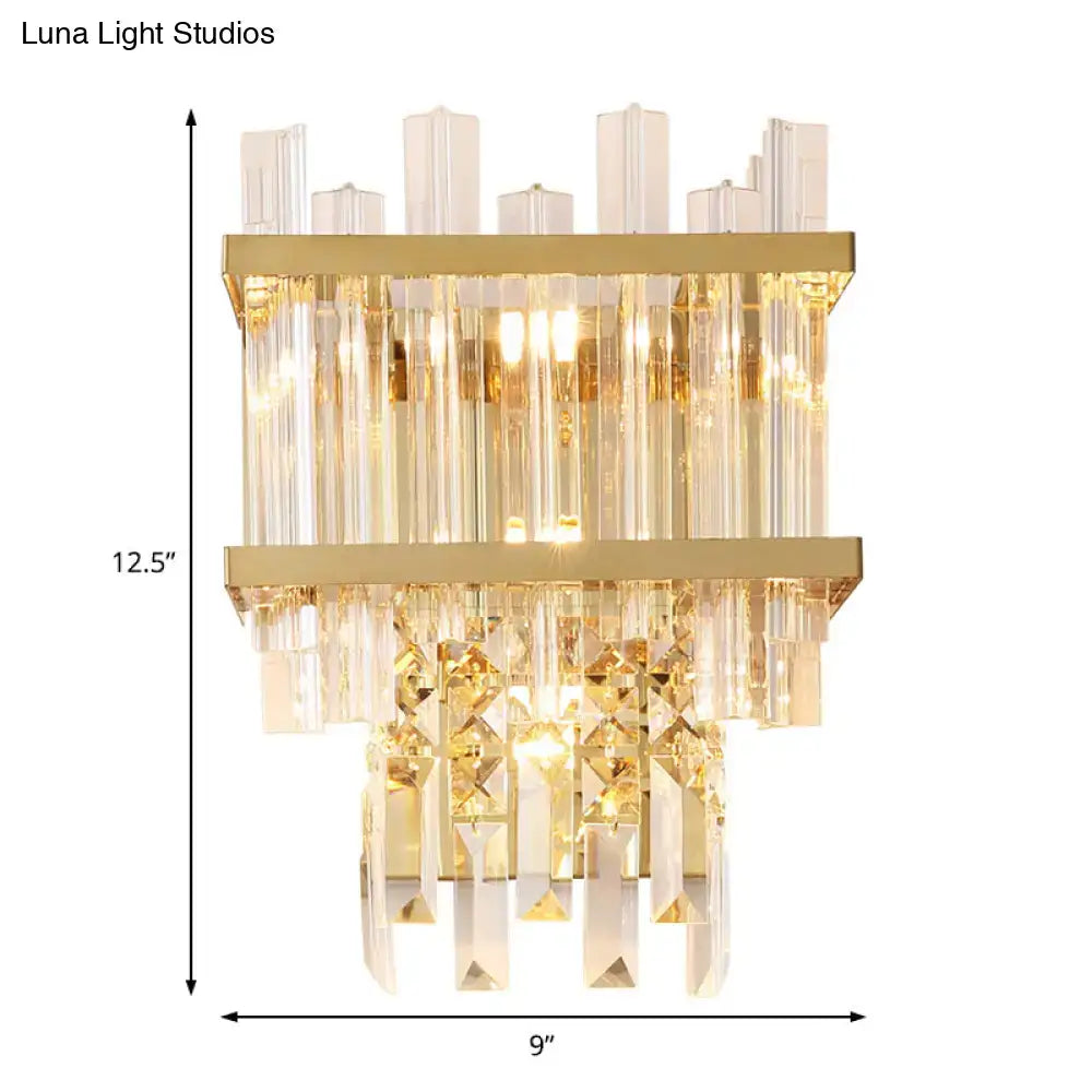 Contemporary brass chrome wall lamp with gold-toned finish and tiered crystal accents for dining room use