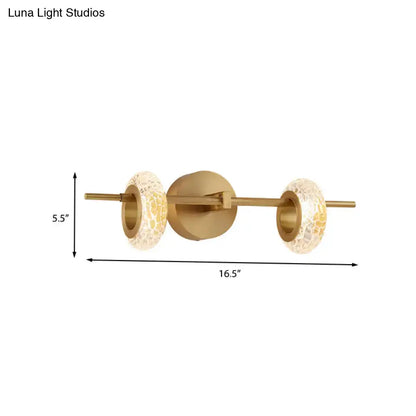 Contemporary brass double oval wall light fixture with gold-toned sconce and warm mosaic glass shades for 220v-240v use
