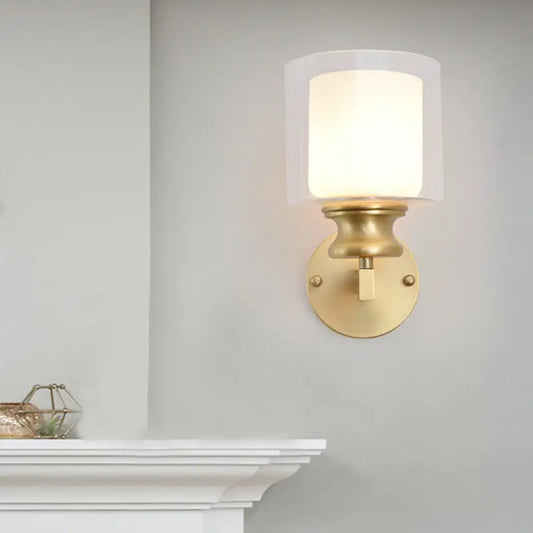 Contemporary brass wall mounted light fixture with frosted glass shade in gold tone for living room use
