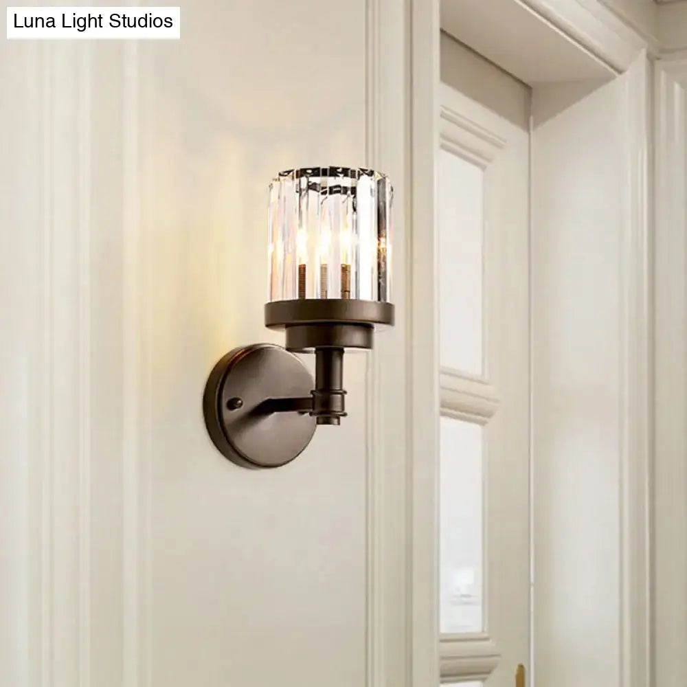 Contemporary bronze wall sconce light fixture with ribbed cylindrical crystal glass shade for hallway lighting