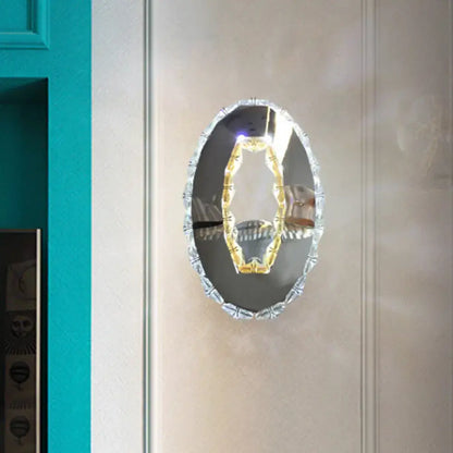 Contemporary chrome crystal oval light fixture mirror with beveled frame and warm white illuminated gold-toned element
