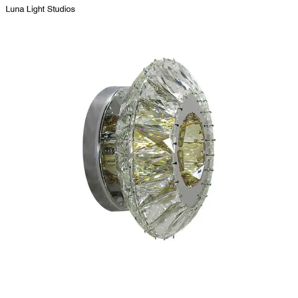 Contemporary chrome wall lamp with circular faceted crystal rings and mirror finish for bedroom lighting