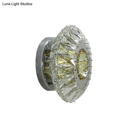 Contemporary chrome wall lamp with circular faceted crystal rings and mirror finish for bedroom lighting