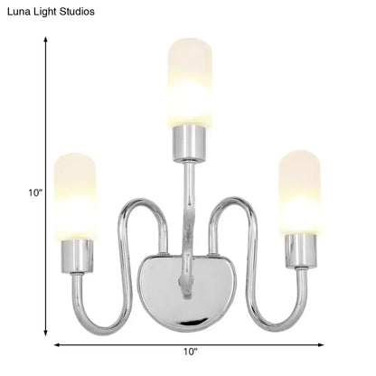 Contemporary chrome three-light wall sconce with frosted milk glass shades for bedroom lighting