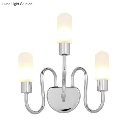 Contemporary chrome three-light wall sconce with frosted milk glass shades for bedroom lighting