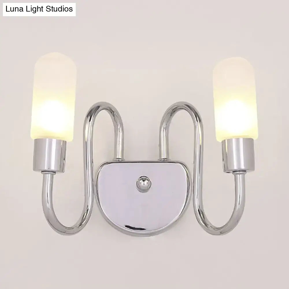 Contemporary chrome double-arm wall sconce with frosted milk glass shades for bedroom lighting