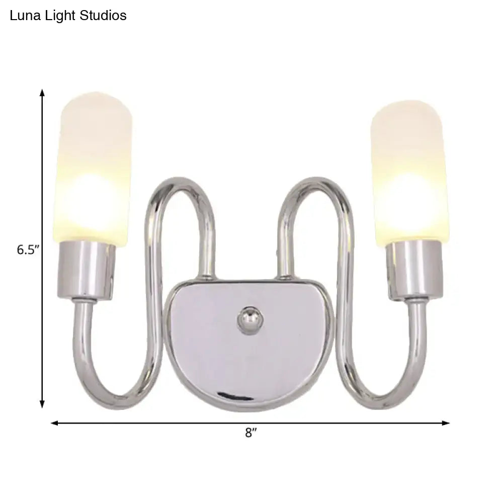 Contemporary chrome double-arm wall sconce with frosted milk glass shades for bedroom lighting