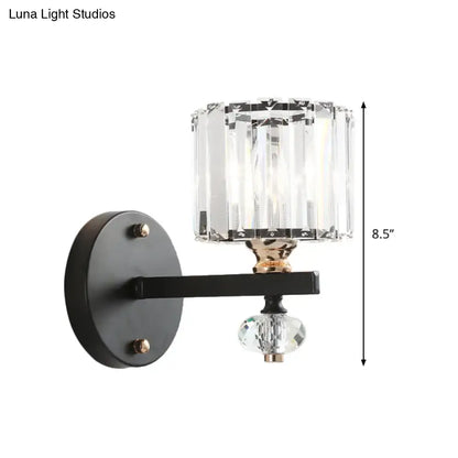 Black metal drum sconce light with contemporary clear ribbed glass cylinder shade and faceted crystal orb pendant