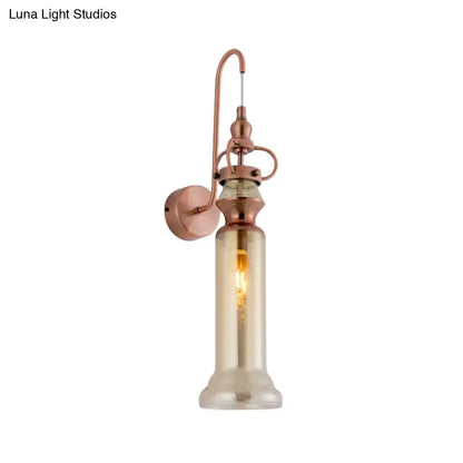 Contemporary copper wall sconce with tall amber-tinted glass cylinder and smoke gray amber glass shade for bedroom lighting